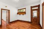 Step into a charming space with original hardwood floors and intricate wooden door frames.