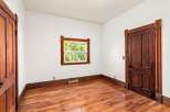 Step into this charming room, featuring stunning hardwood floors and elegant wooden door frames.