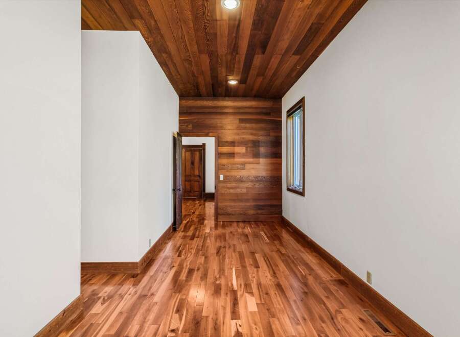 Step into this stunning space featuring exquisite wood flooring and a warm, inviting ambiance.