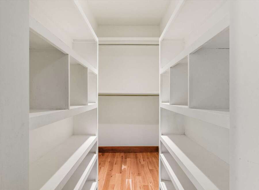 Step into a meticulously designed walk-in closet, offering ample storage and organization.