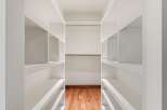 Step into a meticulously designed walk-in closet, offering ample storage and organization.