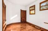 Step into this charming space featuring original hardwood floors and a beautifully crafted wooden door.