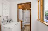 This charming property features a well-lit laundry area with a modern washing machine.
