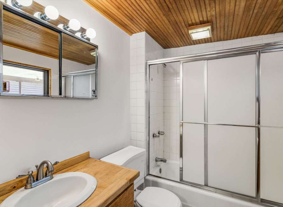 Step into this inviting bathroom featuring a sleek vanity and a bright, well-lit space.