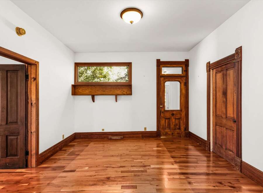 Step into this charming space featuring original hardwood floors and intricate woodwork.