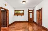 Step into this charming space featuring original hardwood floors and intricate woodwork.
