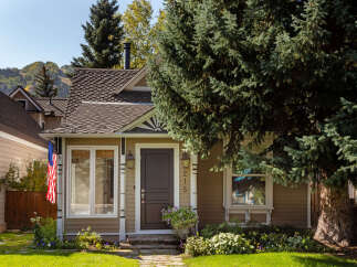 Charming home with a welcoming facade, featuring a well-maintained exterior and inviting front porch.