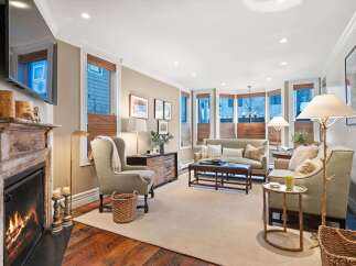 Step into luxury with this stunning living room, featuring a cozy fireplace and elegant decor.