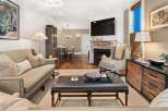 Step into luxury with this stunning living room, featuring a cozy fireplace and a sleek, modern TV.