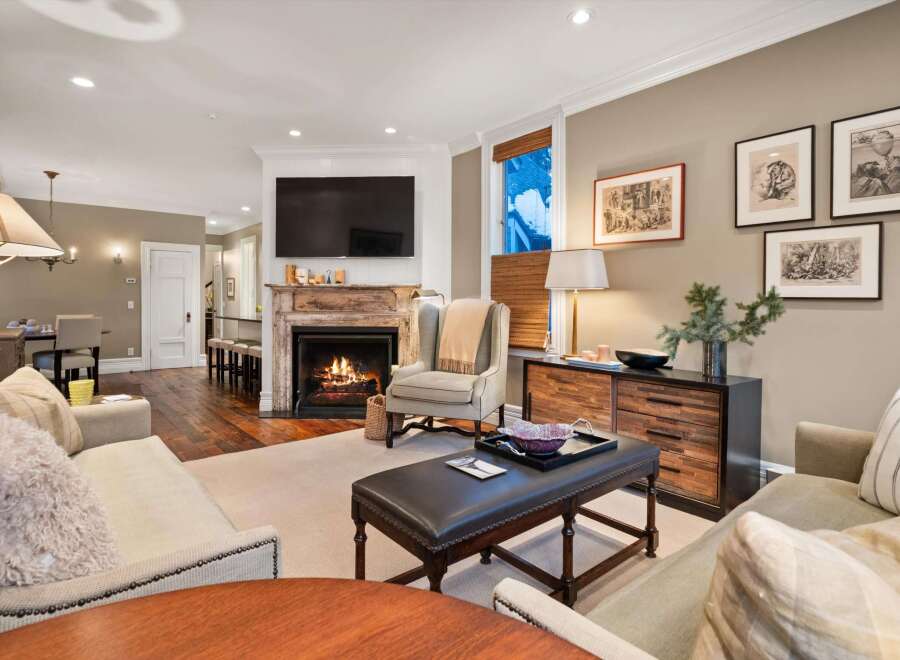 Experience luxury living in this stunning property, featuring a cozy fireplace and elegant decor.