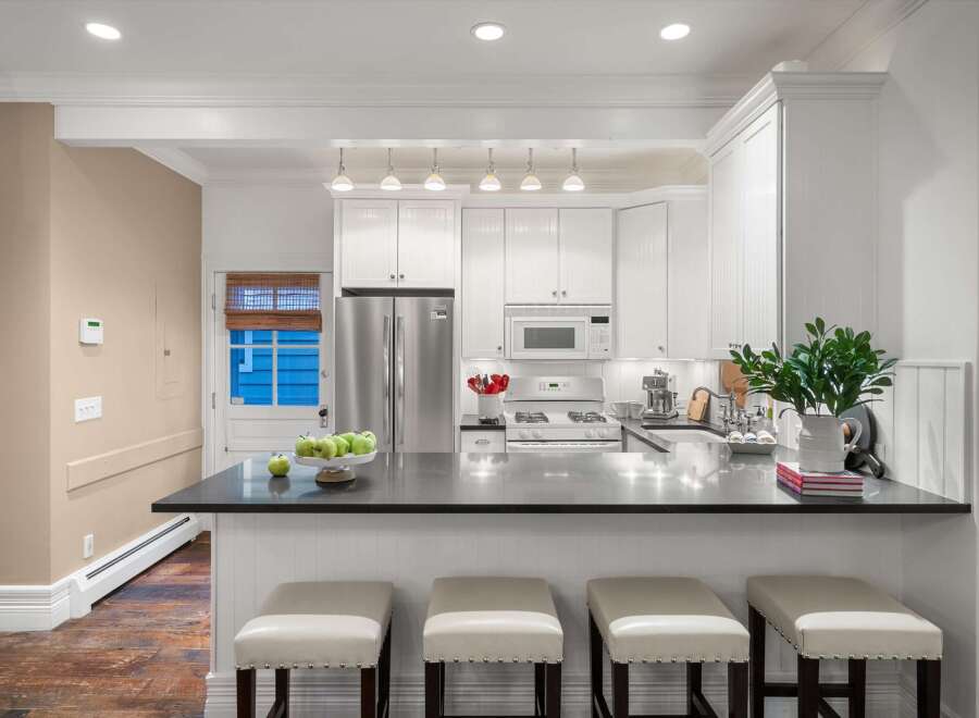 This stunning kitchen boasts a sleek, modern design with a spacious countertop perfect for meal prep and entertaining.