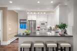 This stunning kitchen boasts a sleek, modern design with a spacious countertop perfect for meal prep and entertaining.