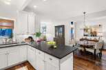 This stunning kitchen boasts a sleek, modern design with a spacious island perfect for meal prep and entertaining.
