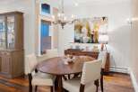 This elegant dining room features a beautiful wooden table and stylish chairs, perfect for hosting gatherings.