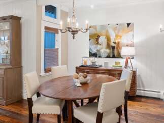 This elegant dining room features a beautiful wooden table and stylish chairs, perfect for hosting gatherings.