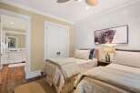 This inviting bedroom features two twin beds, perfect for guests or a shared living space.