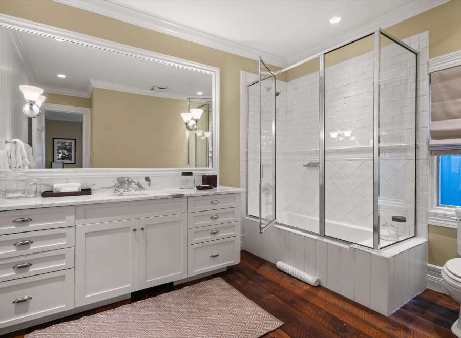 Step into luxury with this stunning bathroom, featuring a spacious vanity with ample storage and a beautiful marble countertop.