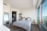 Experience luxury living in this stunning bedroom with breathtaking city views.