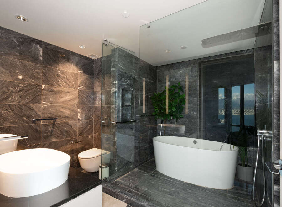 Step into luxury with this stunning bathroom featuring exquisite marble tilework and a sleek, modern design.