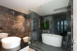 Step into luxury with this stunning bathroom featuring exquisite marble tilework and a sleek, modern design.