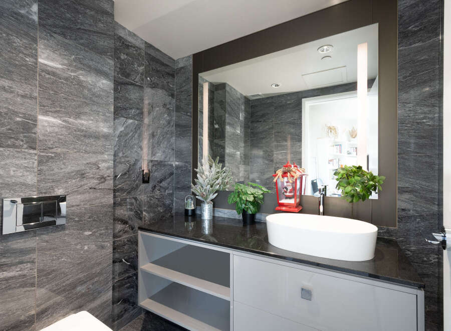 This luxurious bathroom boasts stunning marble walls and a sleek, modern design.