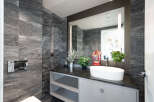 This luxurious bathroom boasts stunning marble walls and a sleek, modern design.