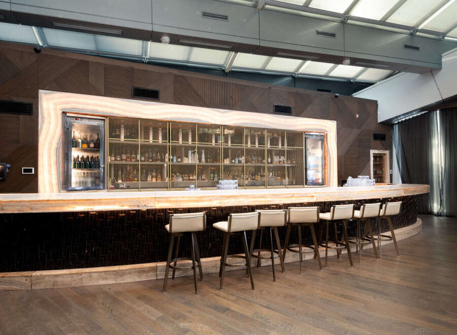 This stunning bar area features a sleek, modern design with high-end finishes.