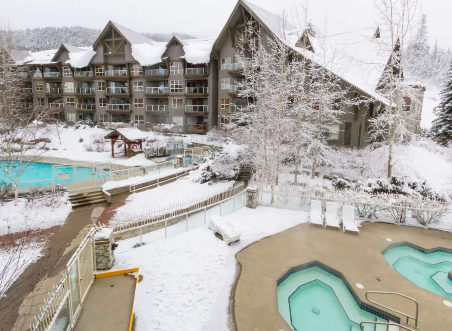 Experience the ultimate winter getaway at this stunning property! Featuring a beautiful outdoor pool and hot tub area, perfect for relaxing after a day on the slopes.