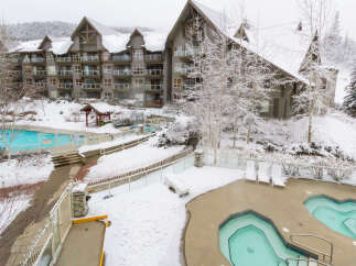 Experience the ultimate winter getaway at this stunning property! Featuring a beautiful outdoor pool and hot tub area, perfect for relaxing after a day on the slopes.