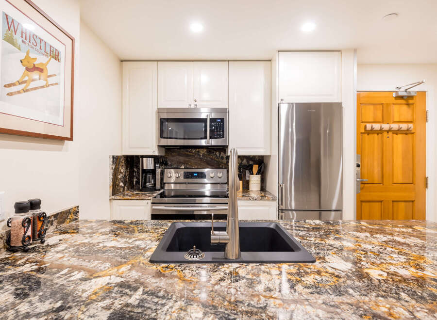 This stunning kitchen boasts modern appliances and elegant granite countertops, perfect for culinary enthusiasts.