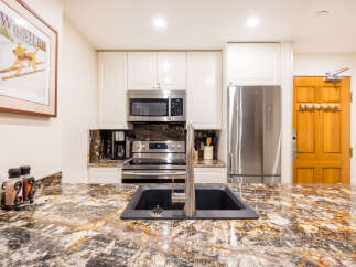 This stunning kitchen boasts modern appliances and elegant granite countertops, perfect for culinary enthusiasts.