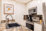 This stunning kitchen boasts modern appliances and elegant granite countertops, perfect for culinary enthusiasts.