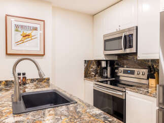 This stunning kitchen boasts modern appliances and elegant granite countertops, perfect for culinary enthusiasts.