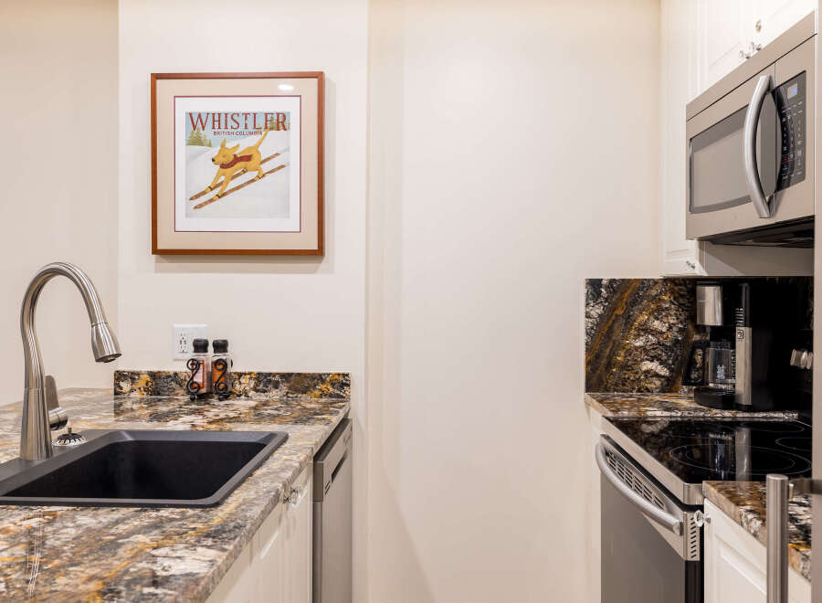 This stunning kitchen boasts modern appliances and elegant granite countertops, perfect for culinary enthusiasts.