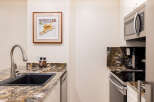 This stunning kitchen boasts modern appliances and elegant granite countertops, perfect for culinary enthusiasts.