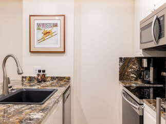 This stunning kitchen boasts modern appliances and elegant granite countertops, perfect for culinary enthusiasts.