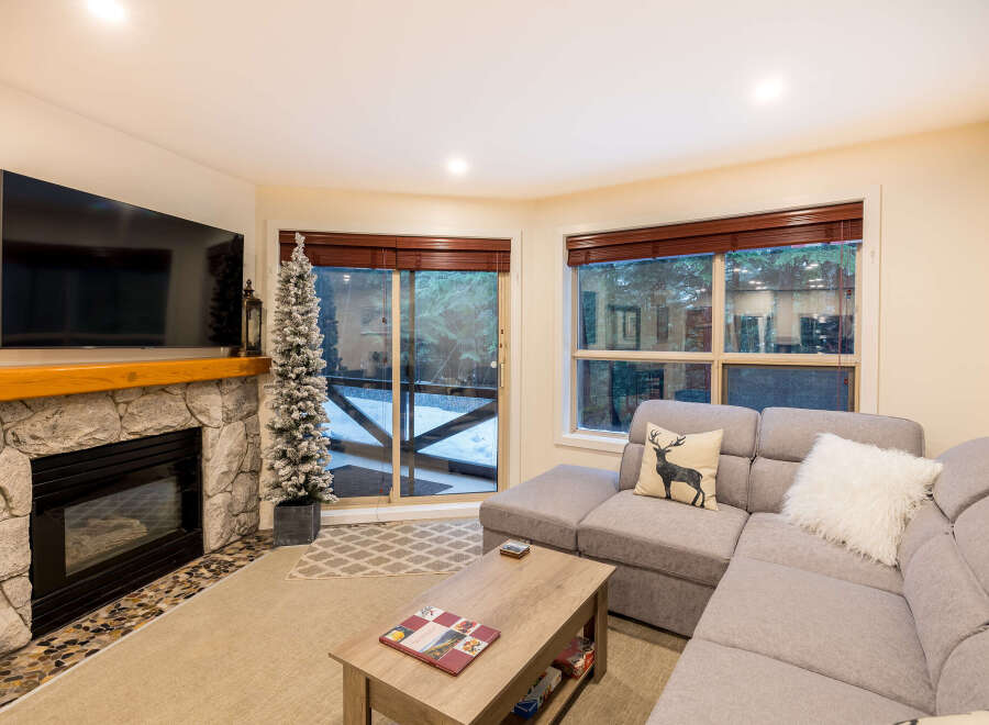 This cozy living room features a stone fireplace, perfect for those chilly evenings.