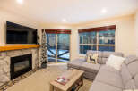 This cozy living room features a stone fireplace, perfect for those chilly evenings.