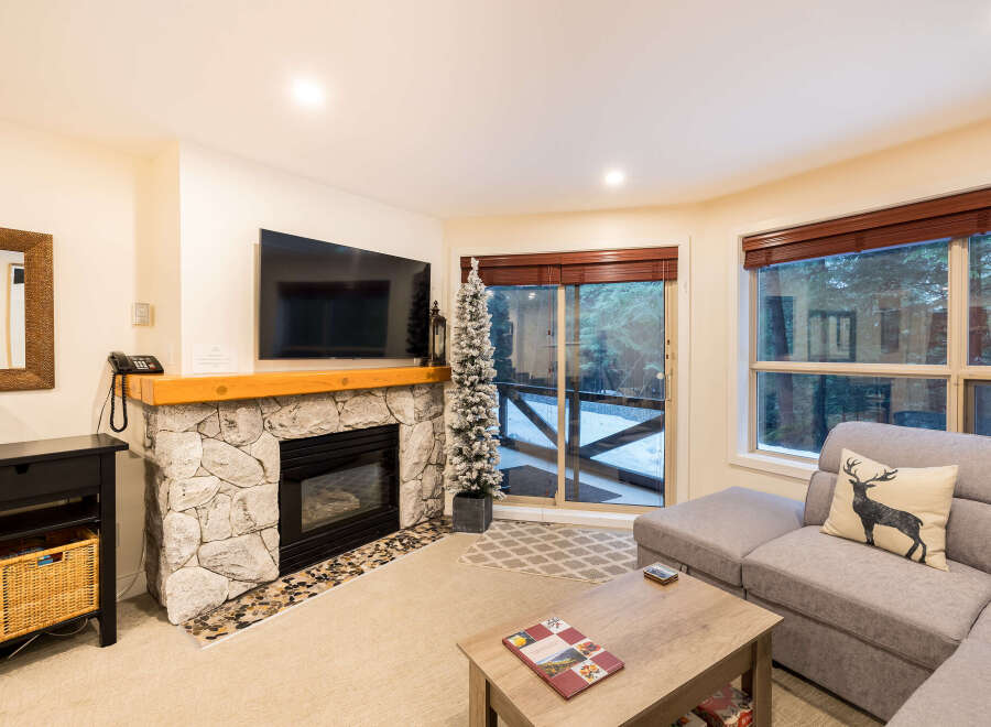Experience cozy living in this stunning property featuring a stone fireplace, perfect for chilly evenings.