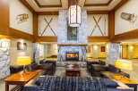 Step into the inviting ambiance of this luxurious lodge, featuring a cozy fireplace and comfortable seating areas.