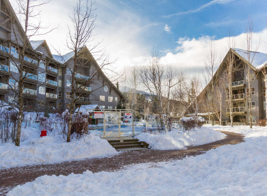 This stunning property offers a serene winter escape with its snow-covered surroundings and charming architecture.
