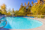 Enjoy the tranquility of this stunning outdoor pool surrounded by vibrant fall foliage.