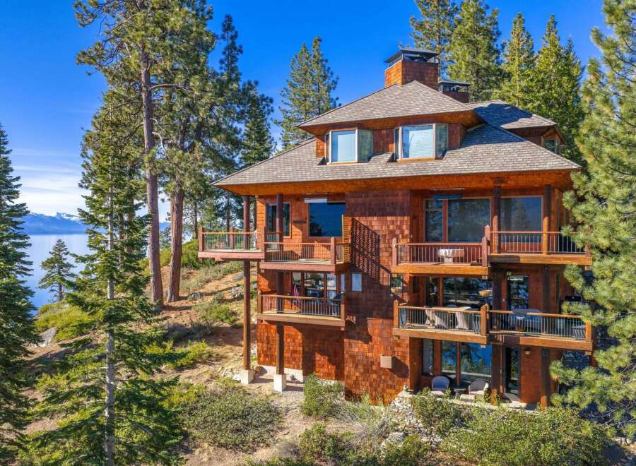 Nestled amidst towering pines, this stunning multi-story home offers breathtaking views of the lake and surrounding mountains.