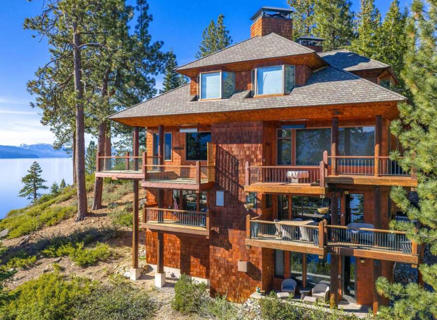 This stunning lakefront property boasts a multi-level design with expansive balconies offering breathtaking views.