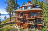 This stunning lakefront property boasts a multi-level design with expansive balconies offering breathtaking views.