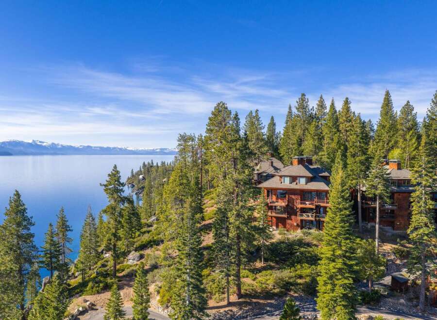 Nestled amidst towering pines, this stunning property offers breathtaking views of the lake and surrounding mountains.