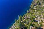 Experience the breathtaking beauty of this stunning property nestled along the serene shoreline.