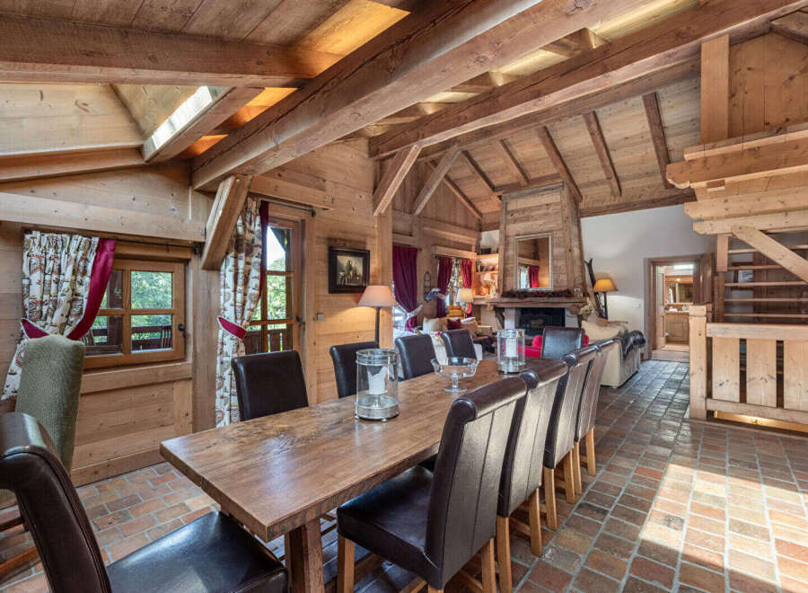 Step into rustic elegance with this stunning property, showcasing a warm and inviting dining area.