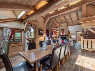Step into rustic elegance with this stunning property, showcasing a warm and inviting dining area.