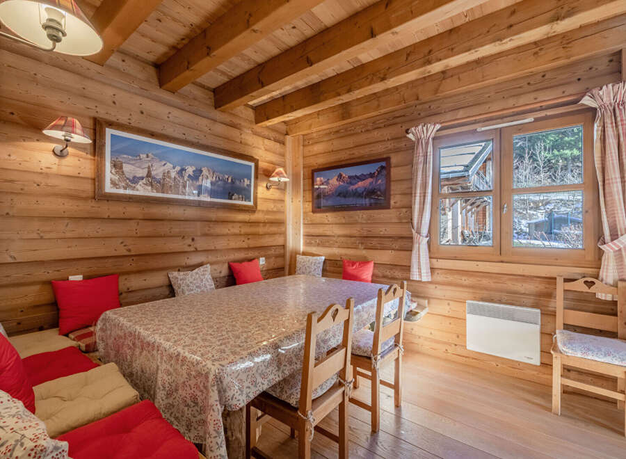 This charming wooden cabin offers a cozy and inviting dining area, perfect for enjoying meals with family and friends.